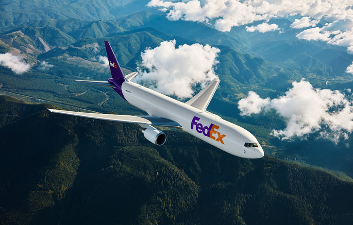 FedEx Plane flying over mountains