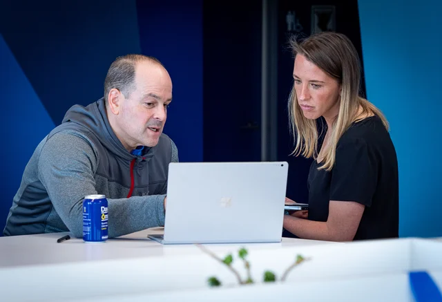 two people problem solving over a laptop