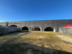 An open yard with metal fencing around it.