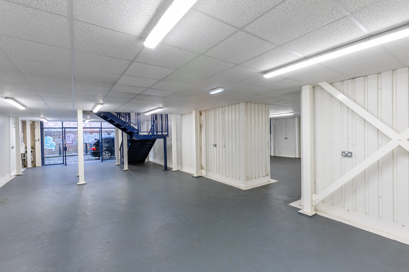 The ground floor of an arch, suitable to use as an office unit, with glazing at the front.