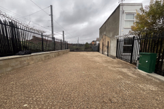 A large plot of land, with metal fencing around it.