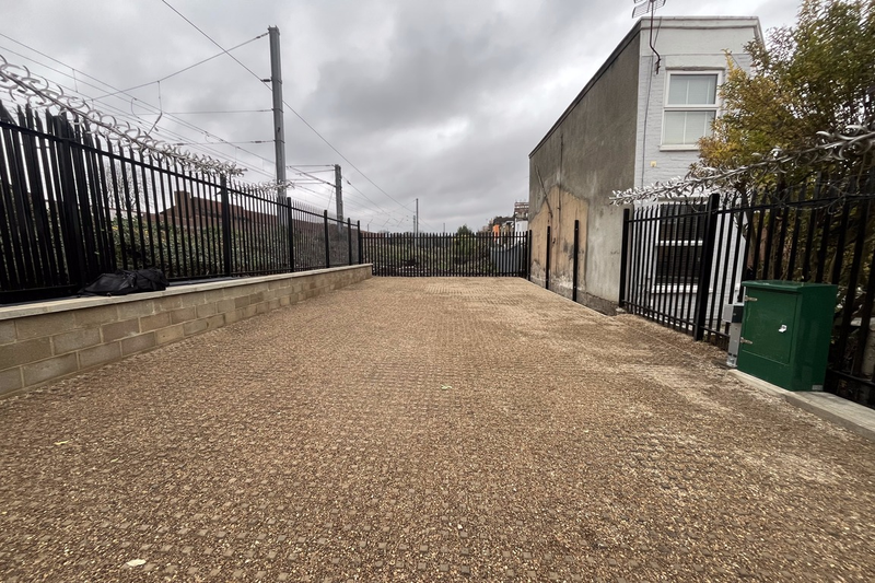 A large plot of land, with metal fencing around it.