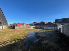 An open yard with metal fencing around it.