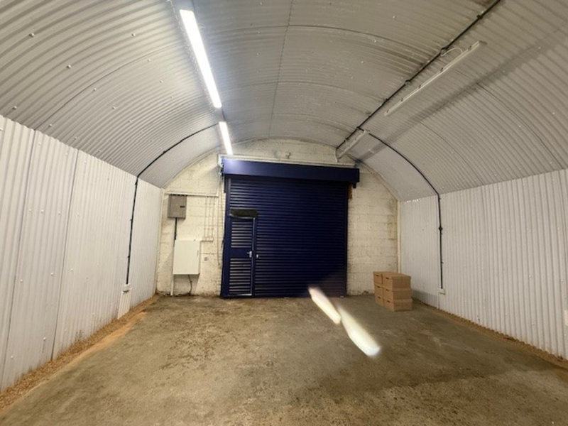 The ground floor of an empty arch, suitable to use as an office unit, with carpet and a WC.