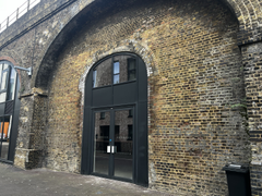 The front of an arch, with glazing on the bottom half and door allowing you to see into the arch interior.
