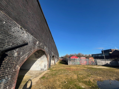 An open yard with metal fencing around it.