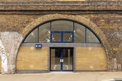 The front of an arch, with glazing on the bottom half and door allowing you to see into the arch interior.