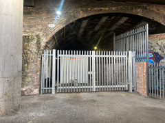 An open yard with metal fencing around it.