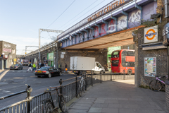 An aerial image showing multiple arches next to each other, with private yards at the front surrounded by metal fencing.

 