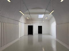 The mezzanine level of an arch with white lining.