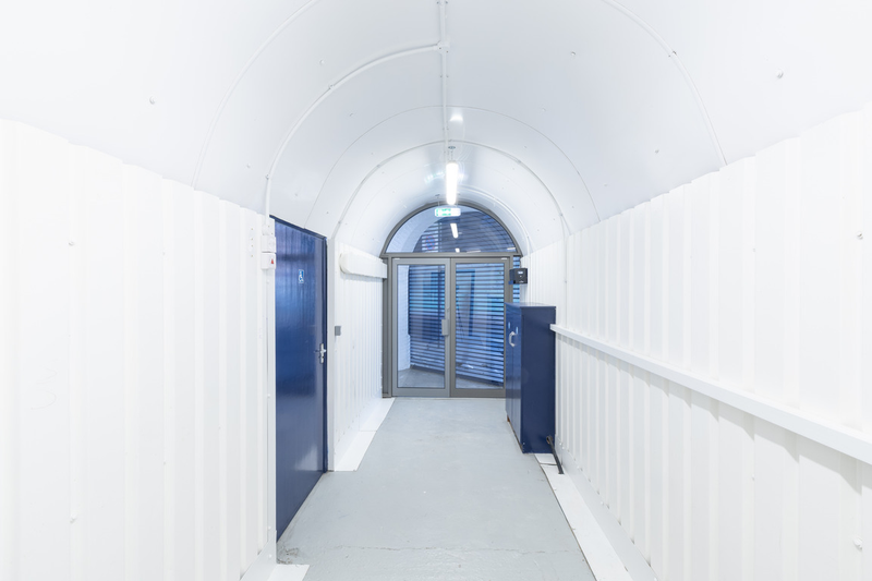 An empty arch with lining and glazing at the front, on the lower level only.