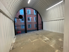 The mezzanine level of an arch with white lining.