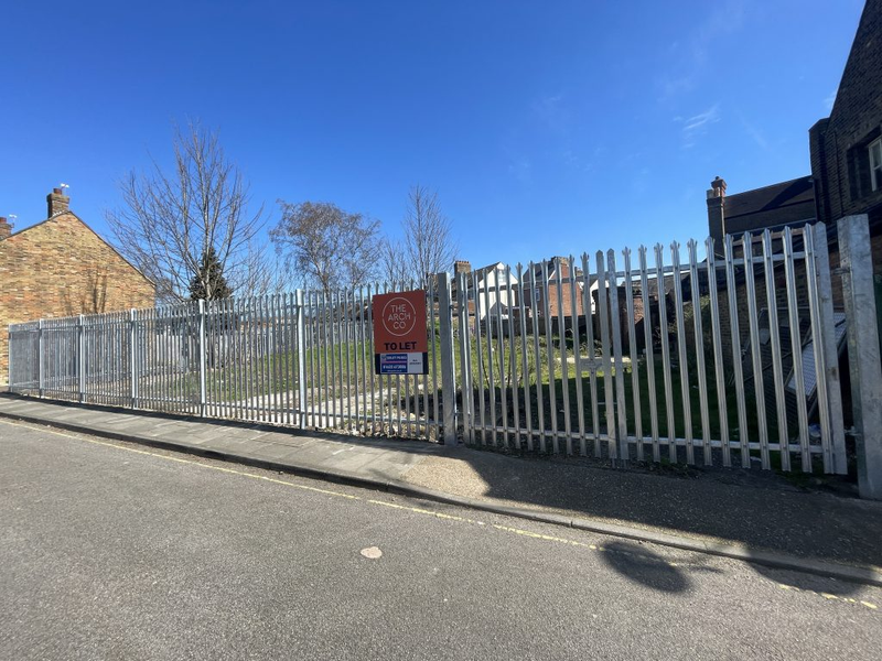 An open yard with metal fencing around it.