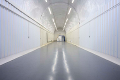 The front of an arch, with glazing on the bottom half and door allowing you to see into the arch interior.