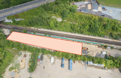 A large plot of land, with metal fencing around it.