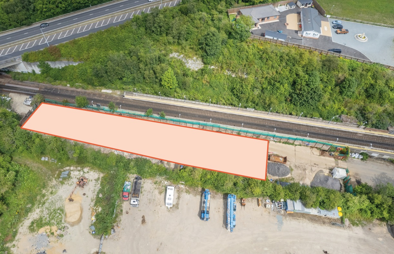 A large plot of land, with metal fencing around it.