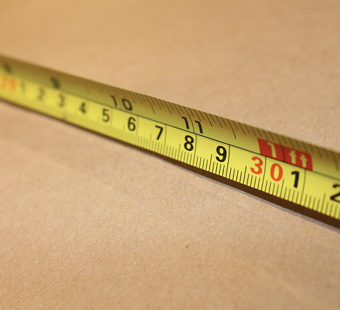 Tape measure being used to measure a box.
