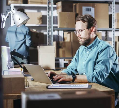 Man working on a computer at his desk in an office.