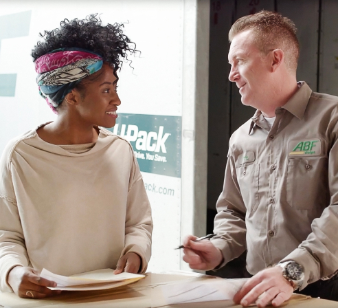 Woman discussing a residential delivery with an ABF driver.