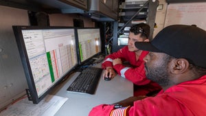 Halliburton employees working with the LOGIX real-time virtual logging tool