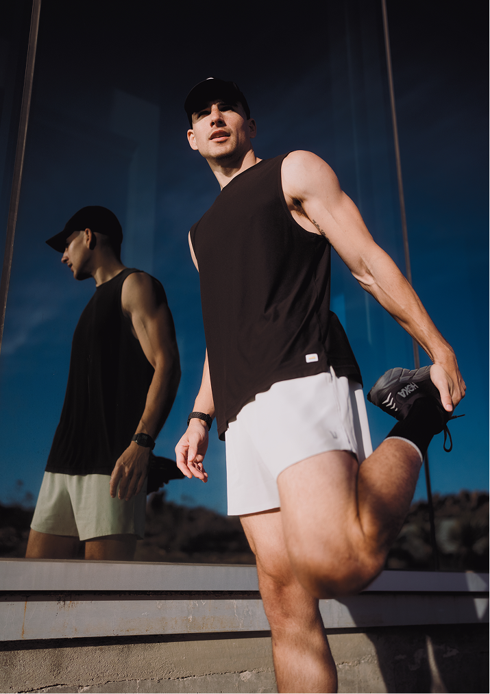 man wearing vuori terrain running shorts