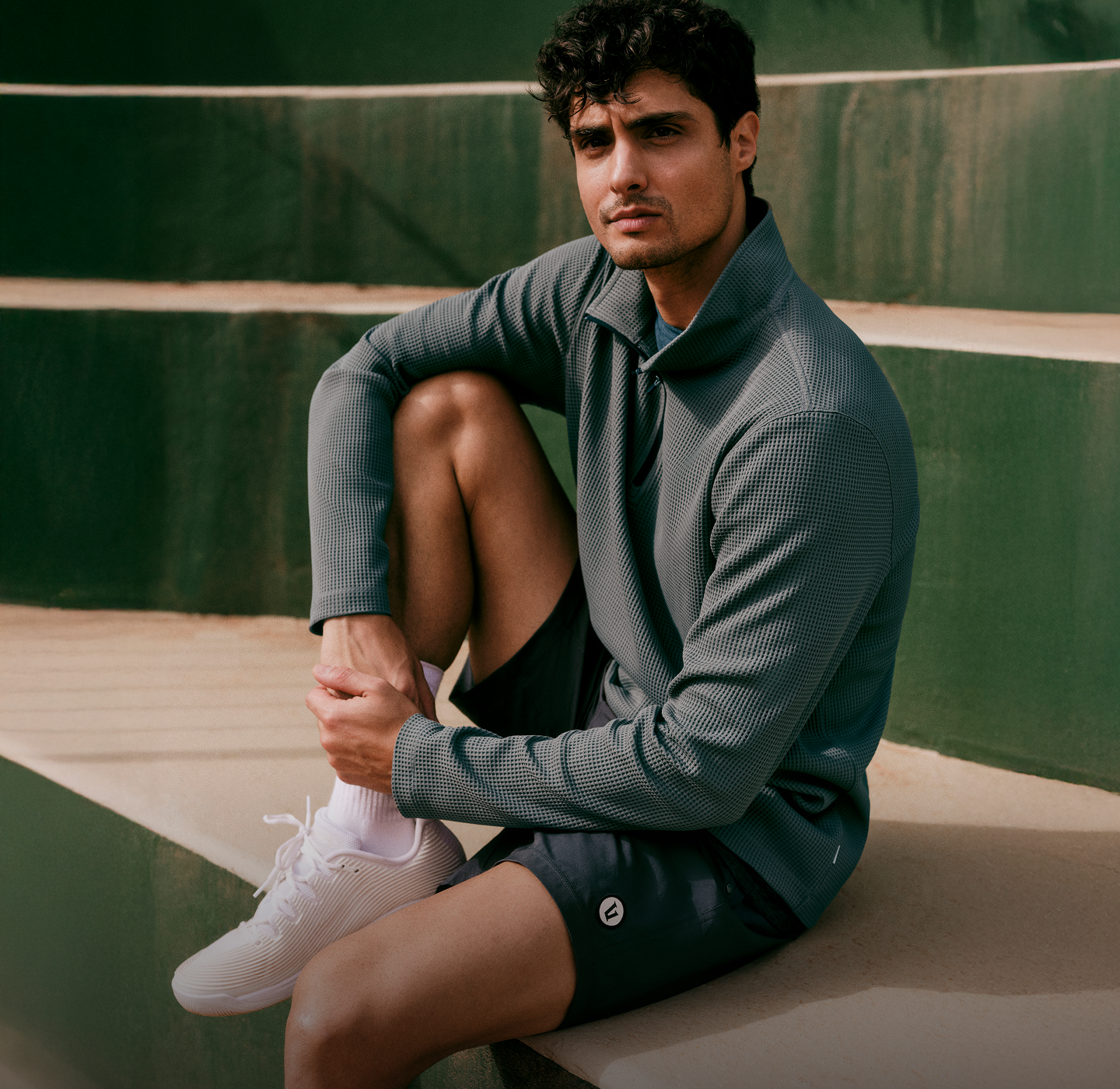 man wearing vuori clothing for tennis
