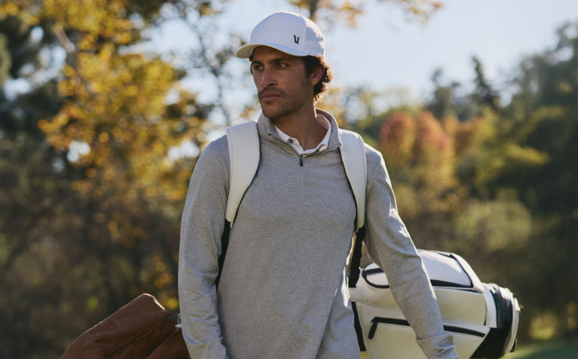 man wearing vuori clothing for golf
