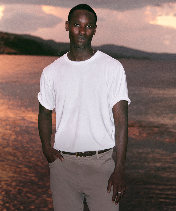 man wearing vuori clothing in front of sunset