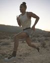 man wearing vuori running through the desert