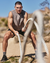 man wearing vuori doing battle ropes