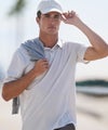 man wearing feather polo
