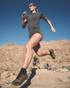 woman wearing vuori running in the desert