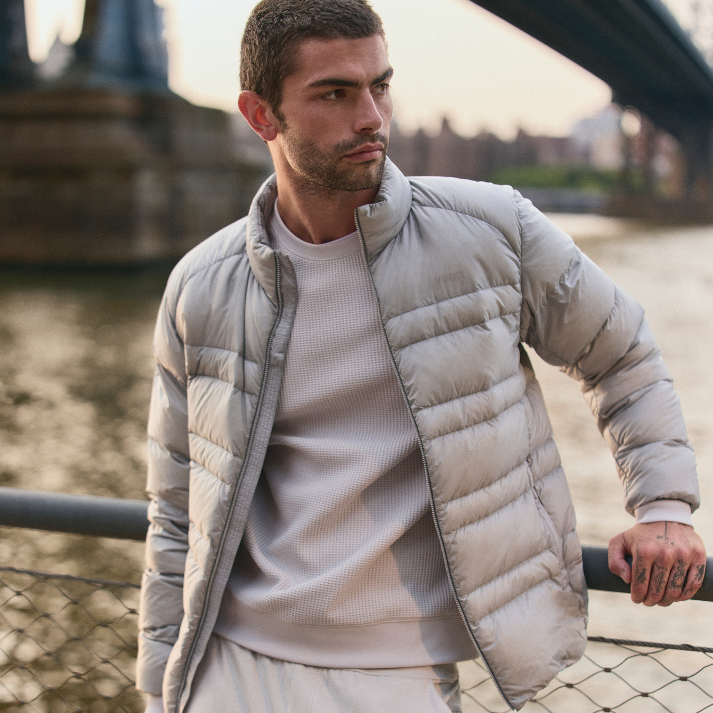 man stretching wearing vuori sunday element hoodie