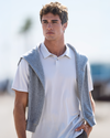 man wearing feather polo