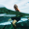 rob machado wearing vuori on surfboard