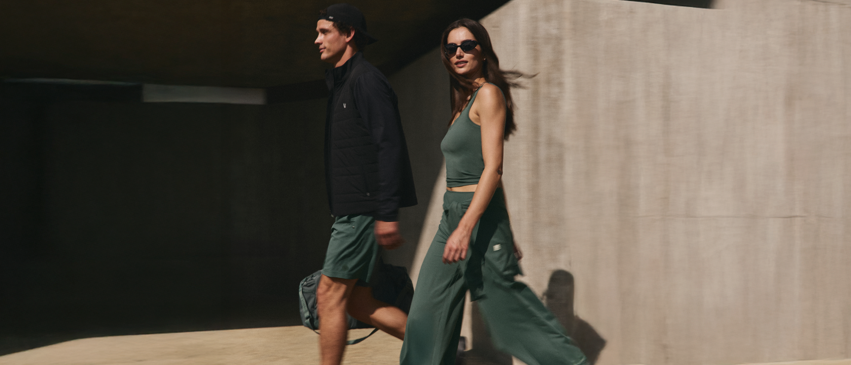 man and woman wearing vuori clothing agate green styles