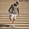 man stretching wearing vuori sunday element hoodie
