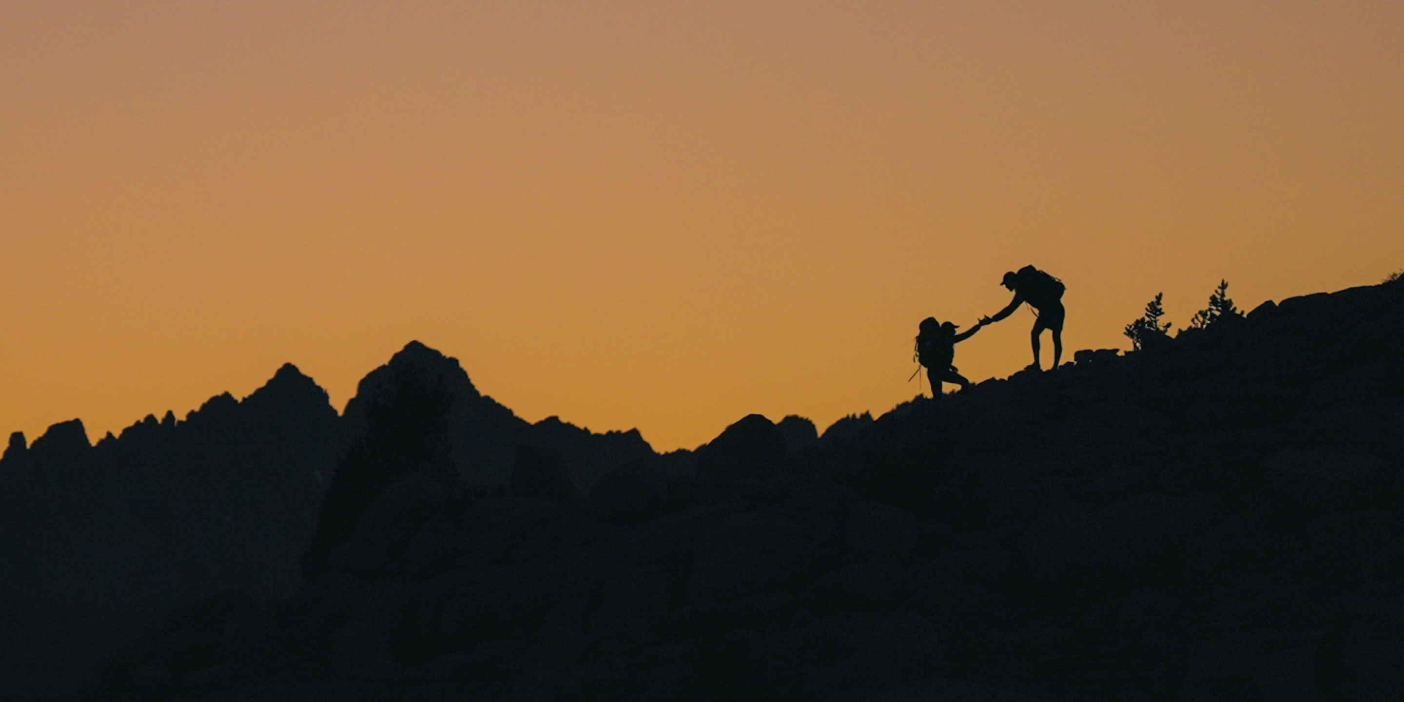people hiking during sunset