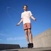 man jumping rope in current tech tee