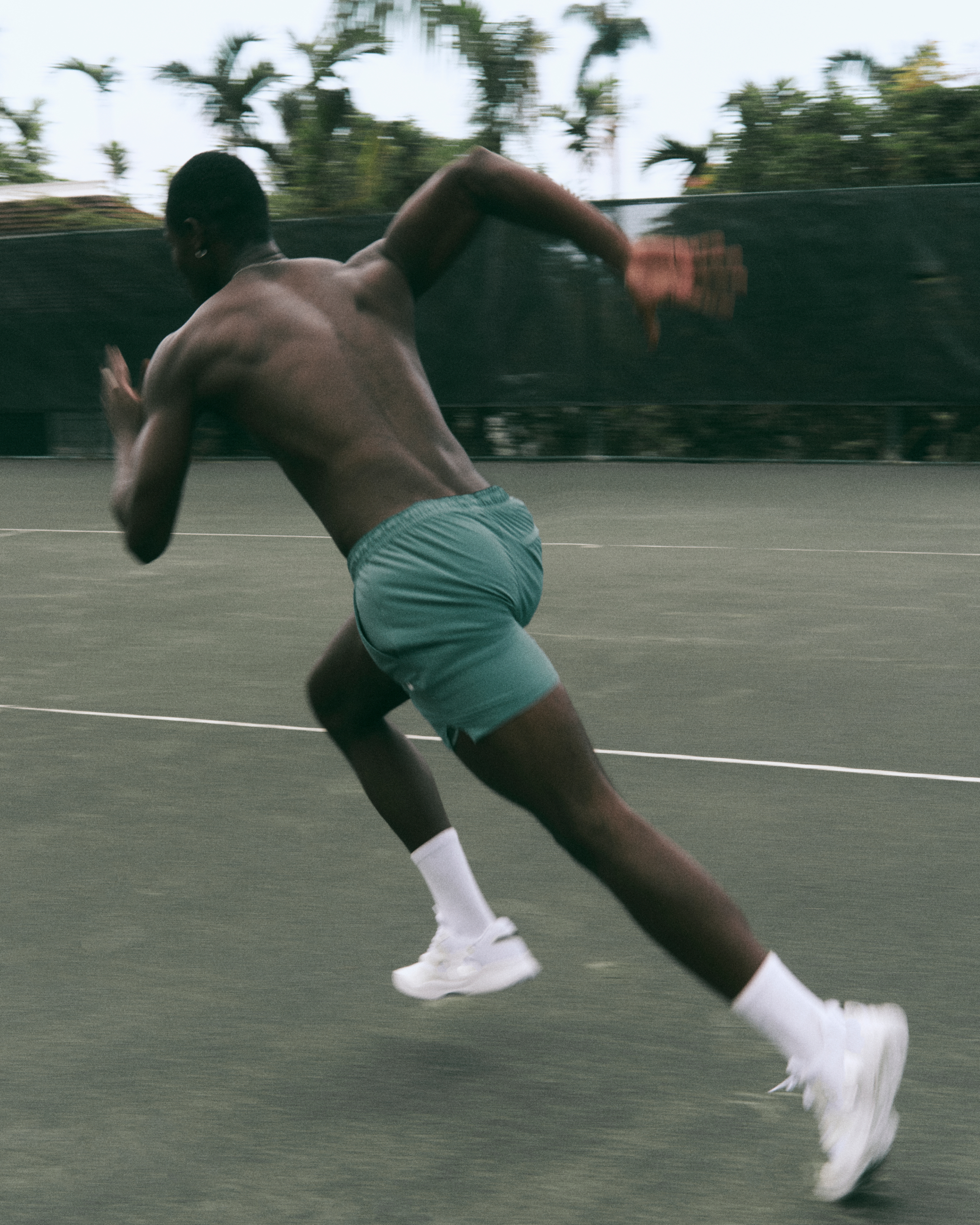 man wearing vuori sprinting