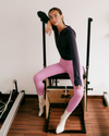 woman on a reformer wearing vuori
