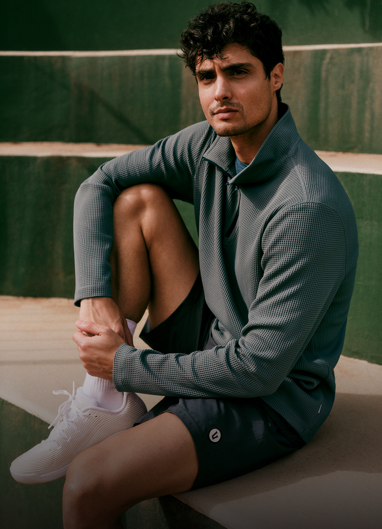 man wearing vuori clothing for tennis