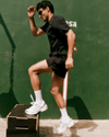 man wearing vuori doing step ups