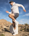 man wearing vuori doing high knees