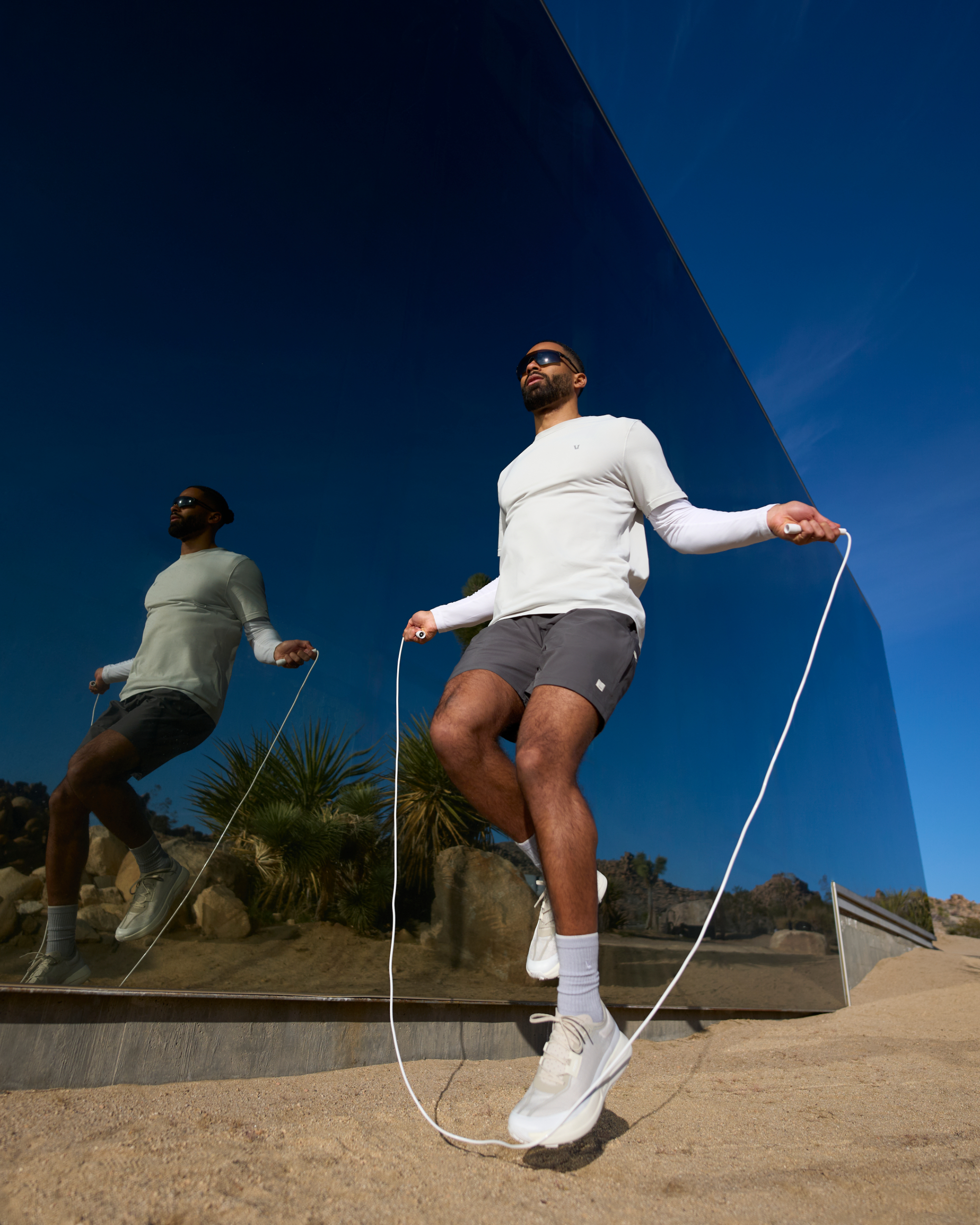 man wearing vuori jumping rope in the desert
