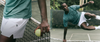 man wearing vuori clothing on tennis court