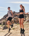 man and woman wearing vuori jumping rope in the desert