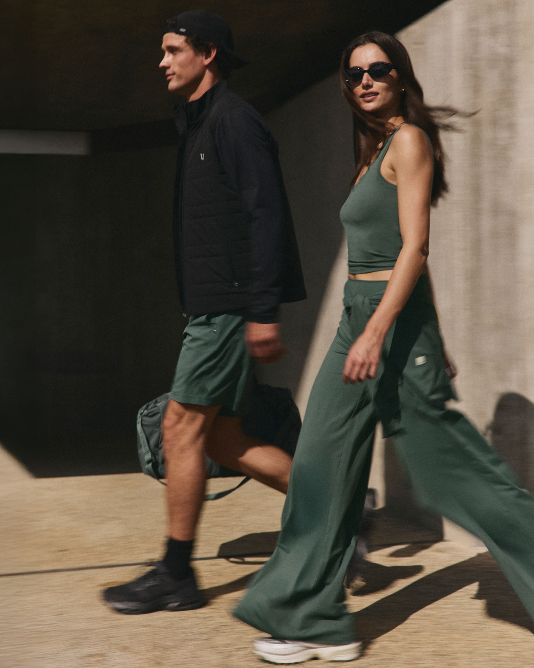 woman and man wearing vuori and walking