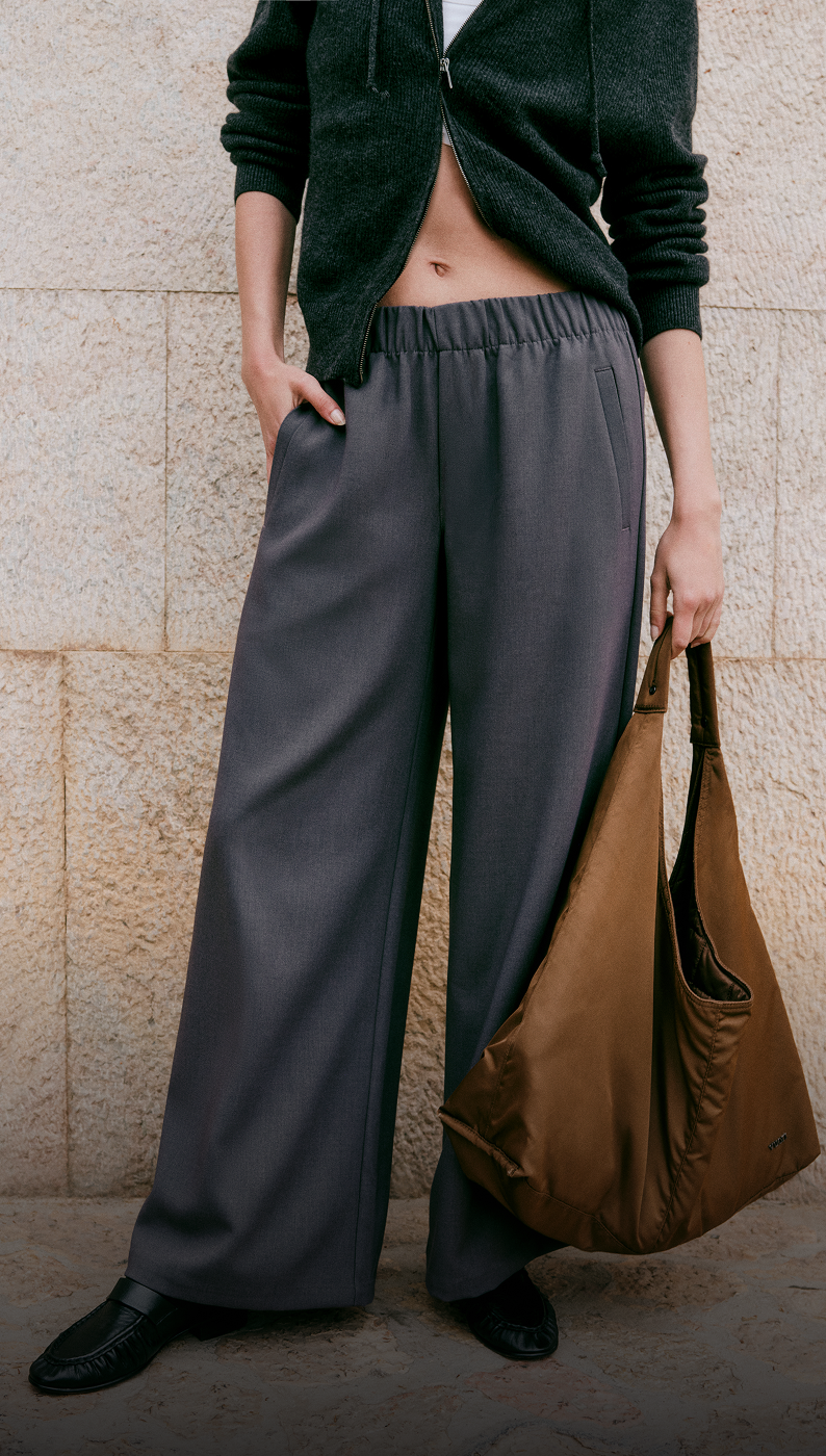 model wearing vuori clothing and arden bag