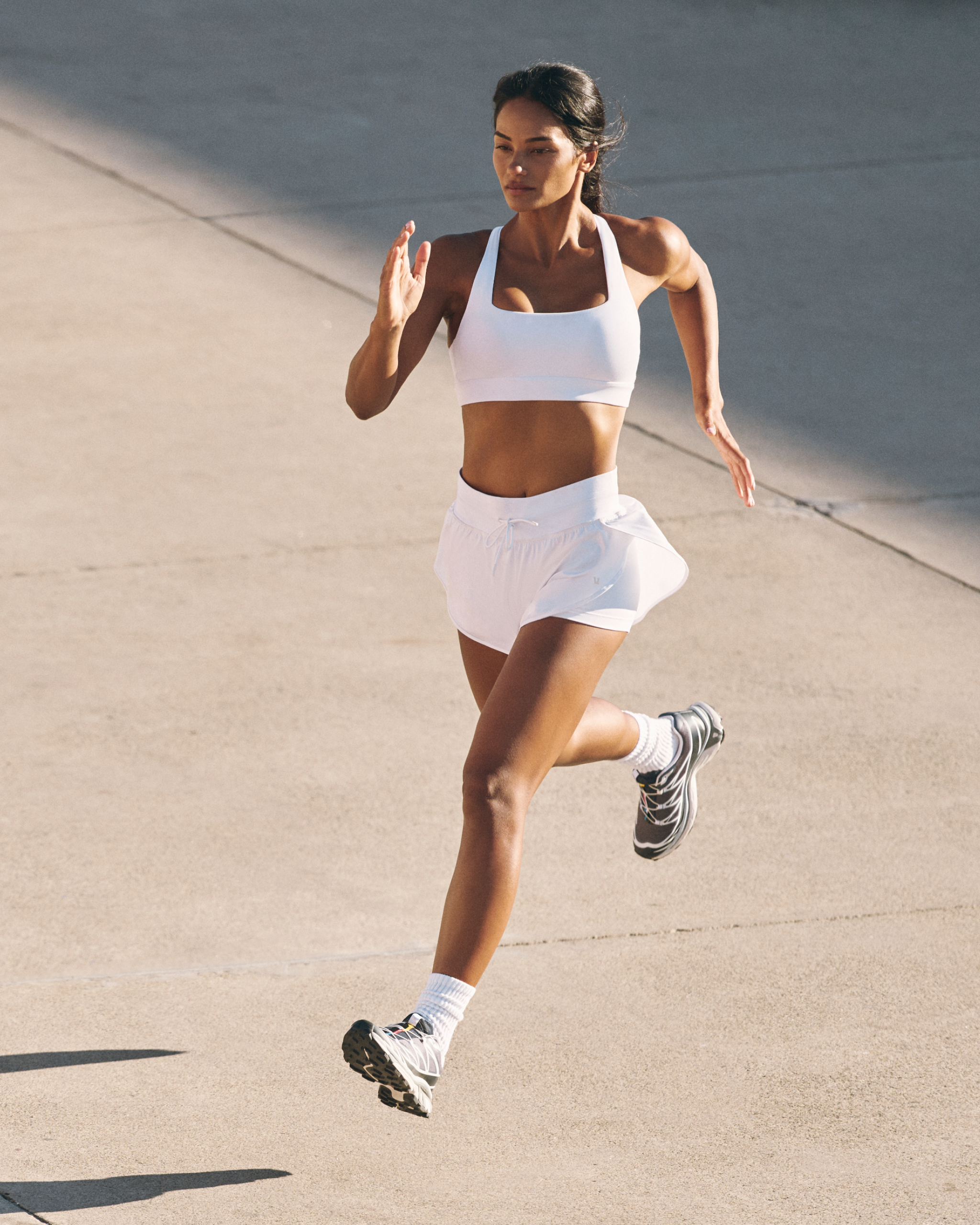 woman wearing vuori running outside
